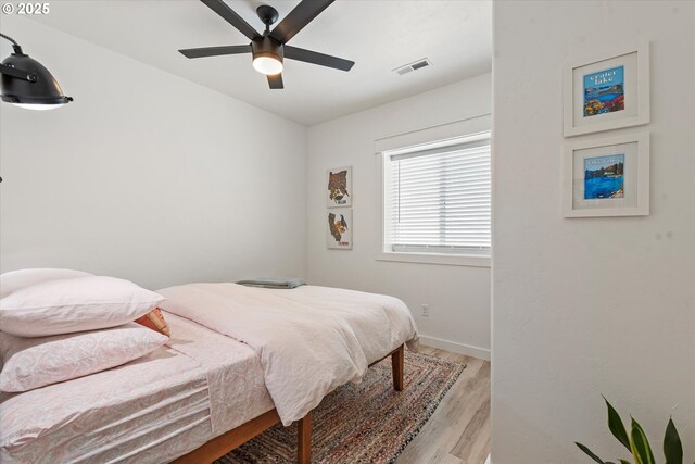 1905 2nd St, Baker City, OR 97814 - bedroom with light wood-style floors, a ceiling fan, and baseboards
