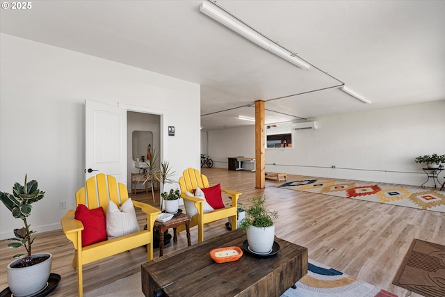 1905 2nd St, Baker City, OR 97814 - living area with wood finished floors, a wall mounted air conditioner, and baseboards