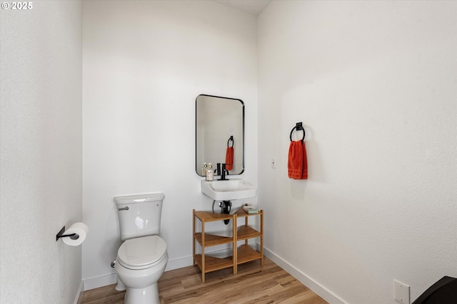 1905 2nd St, Baker City, OR 97814 - bathroom with toilet, wood finished floors, a sink, and baseboards