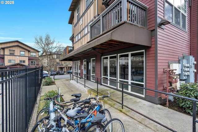 exterior space featuring a balcony and fence