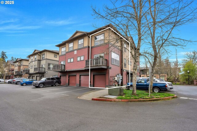 view of property featuring a residential view and uncovered parking