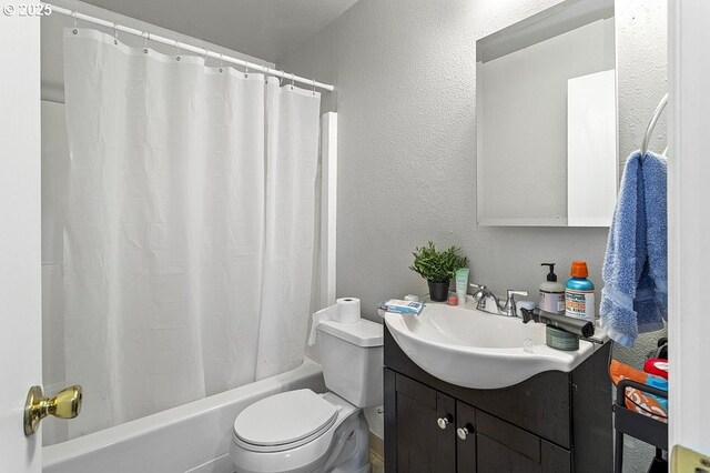 7820 SW 17th Dr, Portland, OR 97219 - bathroom with toilet, vanity, shower / bath combo, and a textured wall