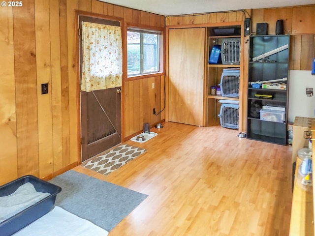 entrance foyer featuring wood finished floors and wood walls