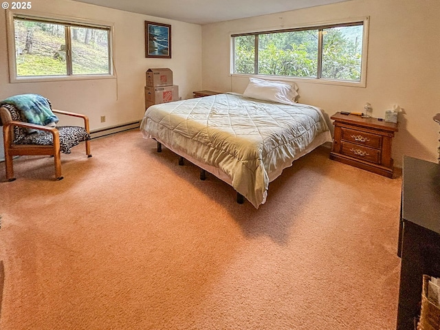 bedroom featuring light colored carpet and a baseboard heating unit