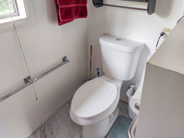 bathroom featuring toilet and marble finish floor