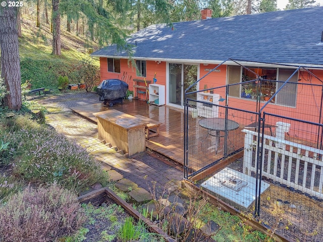 wooden terrace featuring a grill