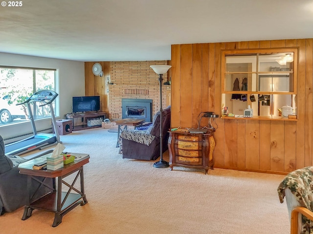 carpeted living room with wood walls and a fireplace