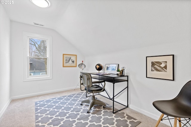 office space with vaulted ceiling and light colored carpet