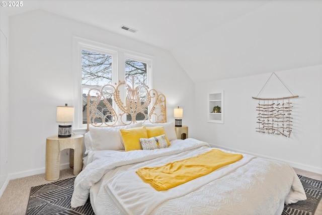 bedroom with lofted ceiling and carpet flooring