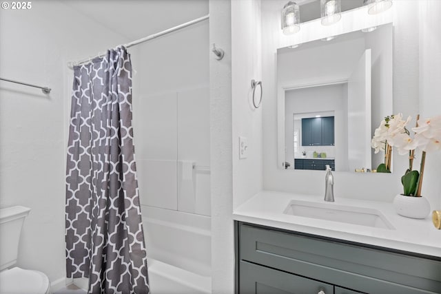 full bathroom featuring vanity, shower / bath combination with curtain, and toilet