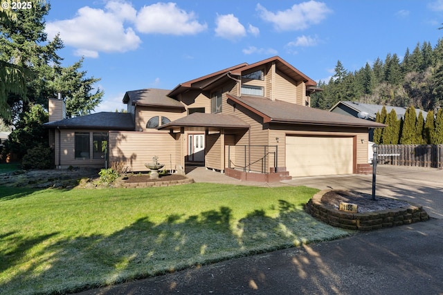 view of front of property with a garage and a front yard