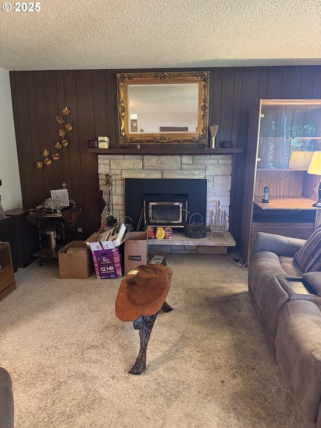 10930 SW 61st Ave, Portland, OR 97219 - living area featuring carpet, a stone fireplace, a textured ceiling, and wood walls