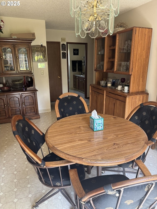 10930 SW 61st Ave, Portland, OR 97219 - dining room with a chandelier and a textured ceiling