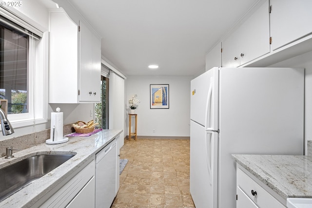 kitchen with white cabinetry, white appliances, and sink