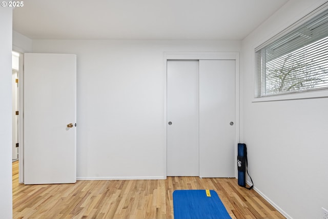 workout room with light hardwood / wood-style flooring