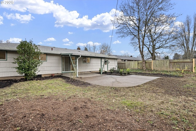 rear view of house with a lawn and a patio area