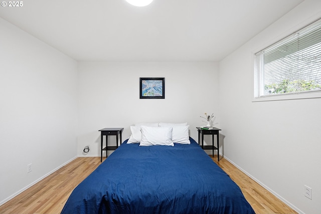 bedroom with hardwood / wood-style floors