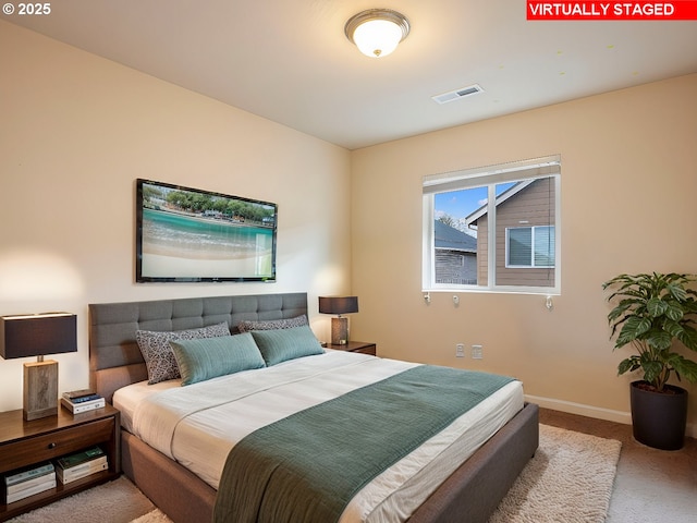 bedroom featuring baseboards, visible vents, and carpet floors