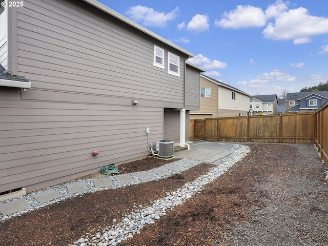 back of house with a patio, cooling unit, a fenced backyard, and a residential view