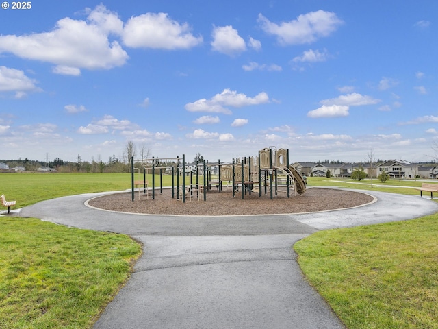 community jungle gym featuring a lawn