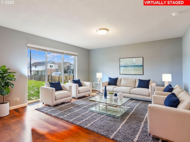 living room with wood finished floors and baseboards