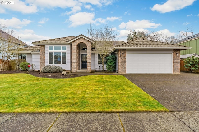 view of front of home with an attached garage, brick siding, a tile roof, driveway, and a front lawn