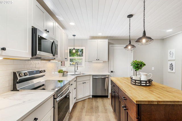 91822 Rulyville Rd, Westport, OR 97016 - kitchen with stainless steel appliances, wood counters, a sink, light wood-type flooring, and recessed lighting