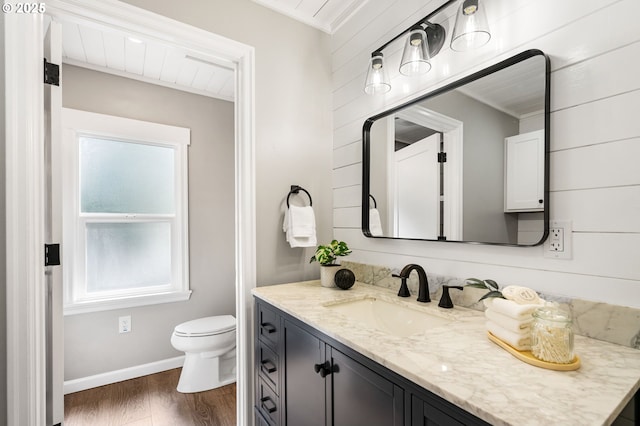 91822 Rulyville Rd, Westport, OR 97016 - bathroom featuring vanity, toilet, wood finished floors, and baseboards