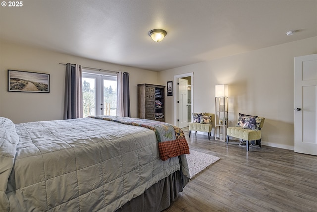 10764 Wiseacre Ln NE, Aurora, OR 97002 - bedroom with french doors, wood finished floors, access to outside, and baseboards