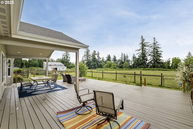 10764 Wiseacre Ln NE, Aurora, OR 97002 - wooden terrace featuring outdoor dining area, a rural view, a yard, and view of scattered trees