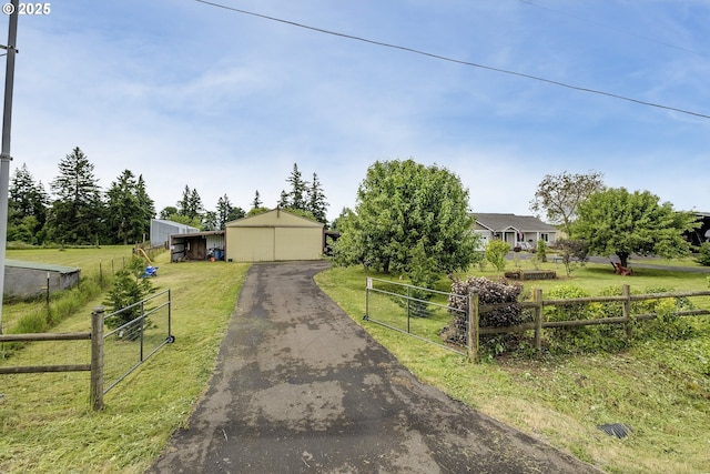10764 Wiseacre Ln NE, Aurora, OR 97002 - view of front facade with a garage, a pole building, and an outbuilding