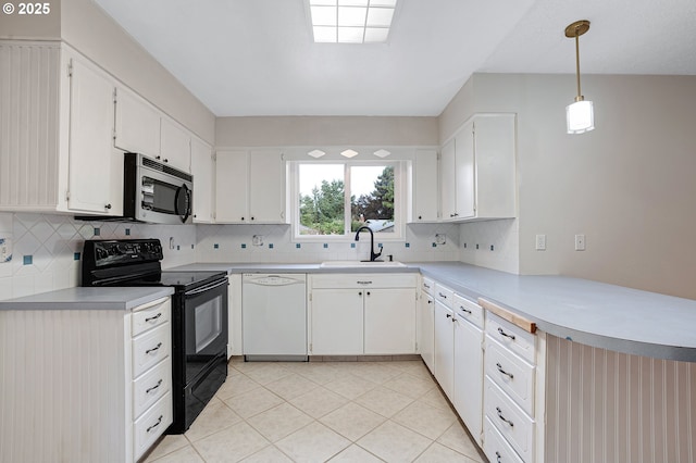 11184 S Allen Ct, Oregon City, OR 97045 - kitchen with stainless steel microwave, black electric range oven, white dishwasher, a peninsula, and backsplash