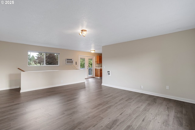 11184 S Allen Ct, Oregon City, OR 97045 - unfurnished living room with a wall mounted AC, dark wood finished floors, and french doors