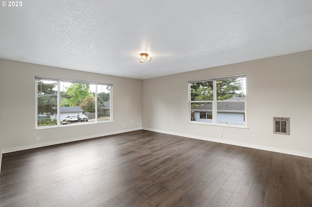 11184 S Allen Ct, Oregon City, OR 97045 - unfurnished room featuring dark wood-type flooring, a textured ceiling, and heating unit