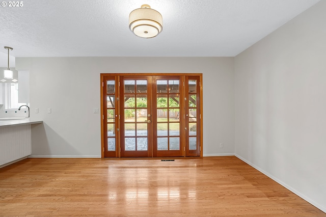 11184 S Allen Ct, Oregon City, OR 97045 - entryway with plenty of natural light, light wood finished floors, a textured ceiling, and french doors