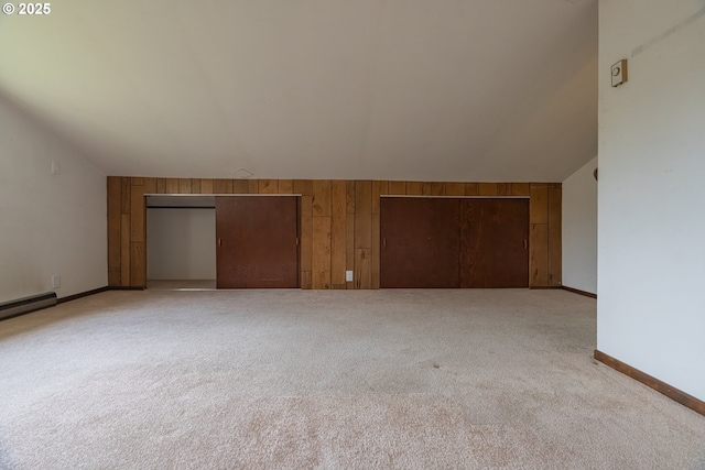 1185 NE Queens Ln, Hillsboro, OR 97124 - additional living space featuring wood walls, baseboards, vaulted ceiling, and light carpet