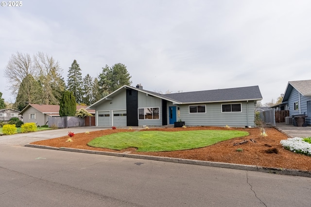 1185 NE Queens Ln, Hillsboro, OR 97124 - view of front of house featuring fence, a front lawn, an attached garage, a chimney, and driveway