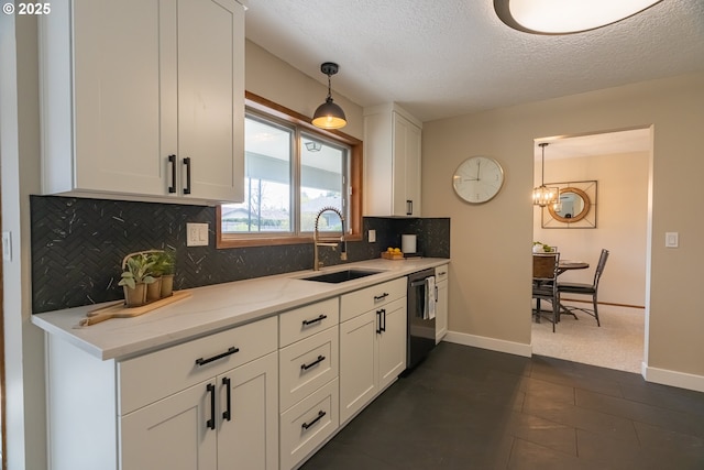 1185 NE Queens Ln, Hillsboro, OR 97124 - kitchen featuring a textured ceiling, white cabinetry, dishwasher, a sink, and decorative backsplash