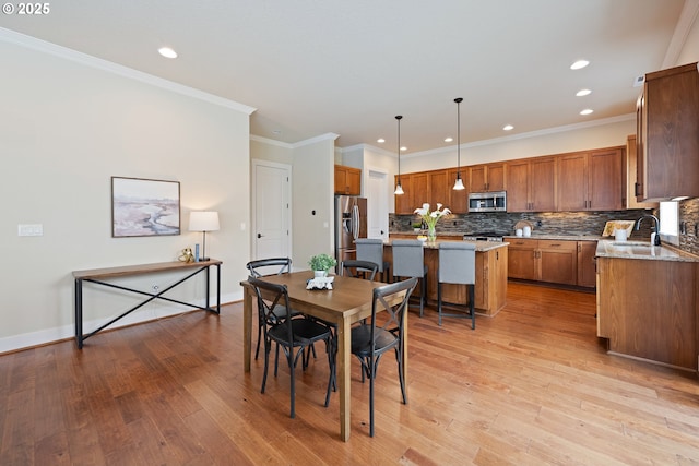 15152 NW Marie Way, Portland, OR 97229 - dining room with recessed lighting, light wood finished floors, crown molding, and baseboards