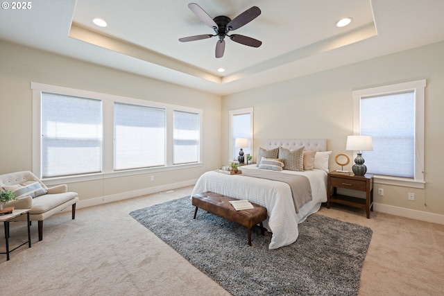 15152 NW Marie Way, Portland, OR 97229 - bedroom featuring light carpet, a tray ceiling, recessed lighting, baseboards, and a ceiling fan