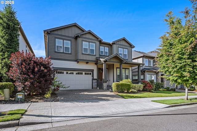 15152 NW Marie Way, Portland, OR 97229 - view of front facade featuring an attached garage, asphalt driveway, stone siding, and board and batten siding