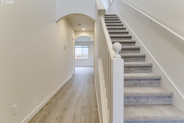 staircase with wood-type flooring