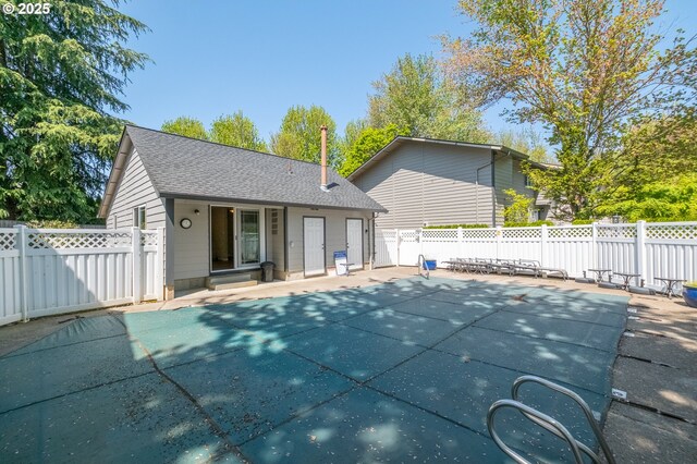 exterior space featuring a fenced in pool, a patio area, and fence