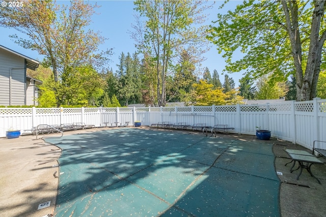 view of pool featuring a fenced in pool, a fenced backyard, and a patio area