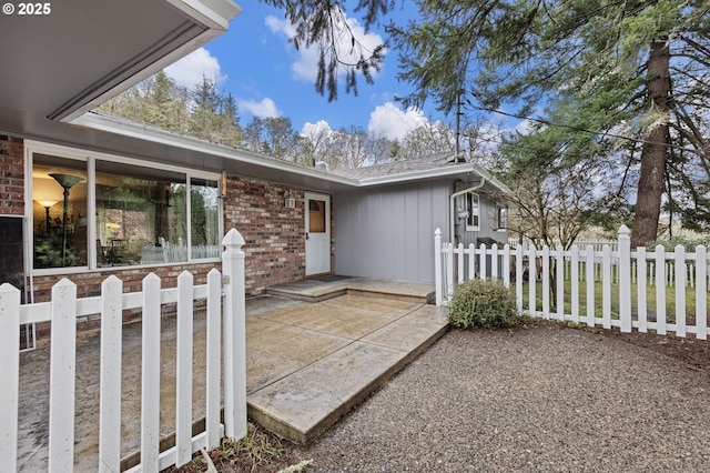 exterior space with a patio, brick siding, and fence