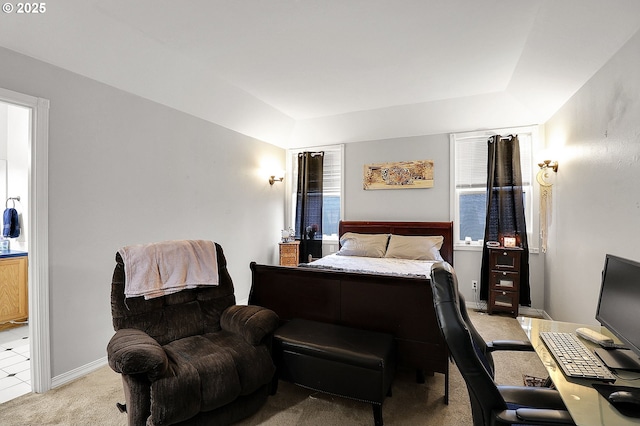 bedroom featuring baseboards, a tray ceiling, and light colored carpet