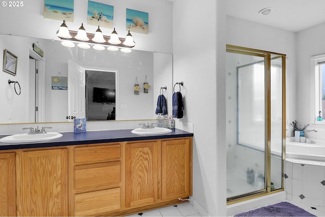 full bath featuring tile patterned floors, a sink, a shower stall, and double vanity