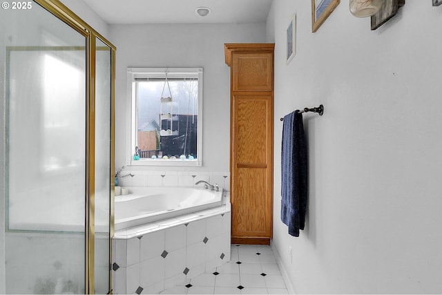 bathroom featuring a stall shower, visible vents, baseboards, tile patterned floors, and a garden tub