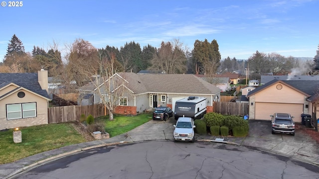 view of front of home with a garage and a front lawn