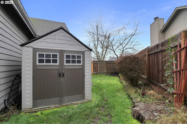 view of shed with a fenced backyard